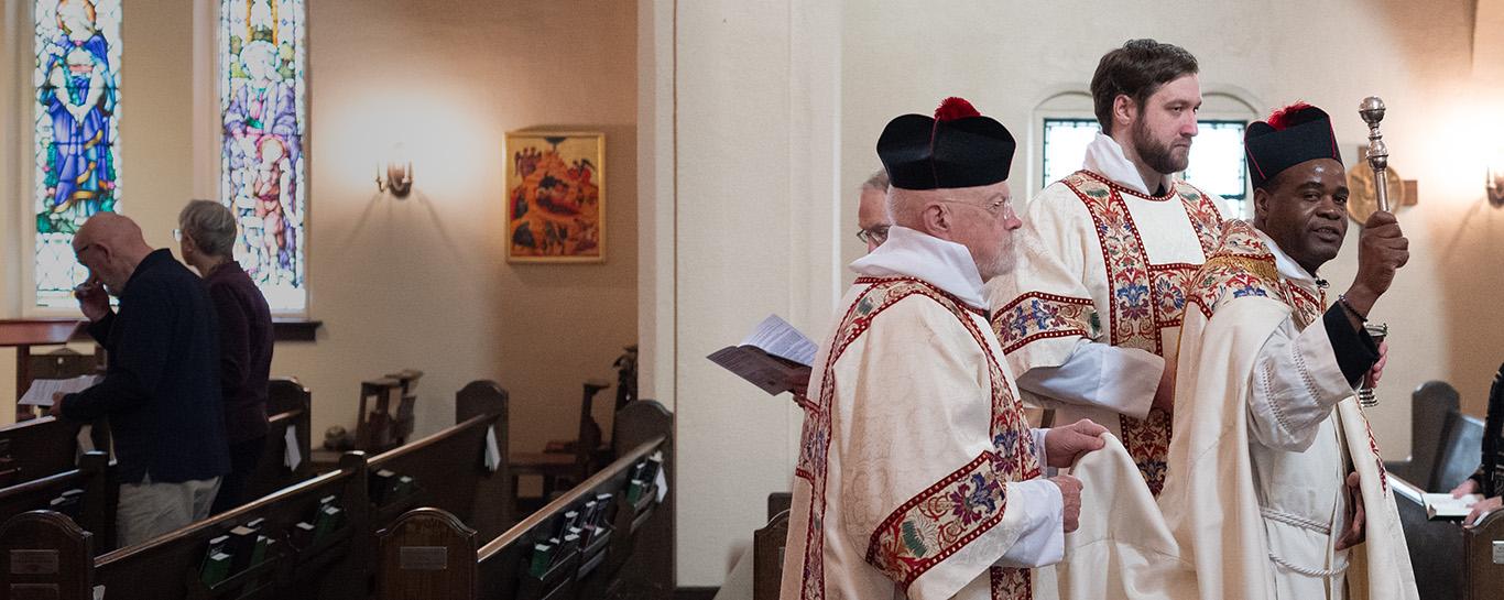 Celebrants walking down the aisle during Asperges