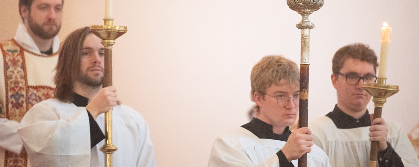 A closeup of servers in procession