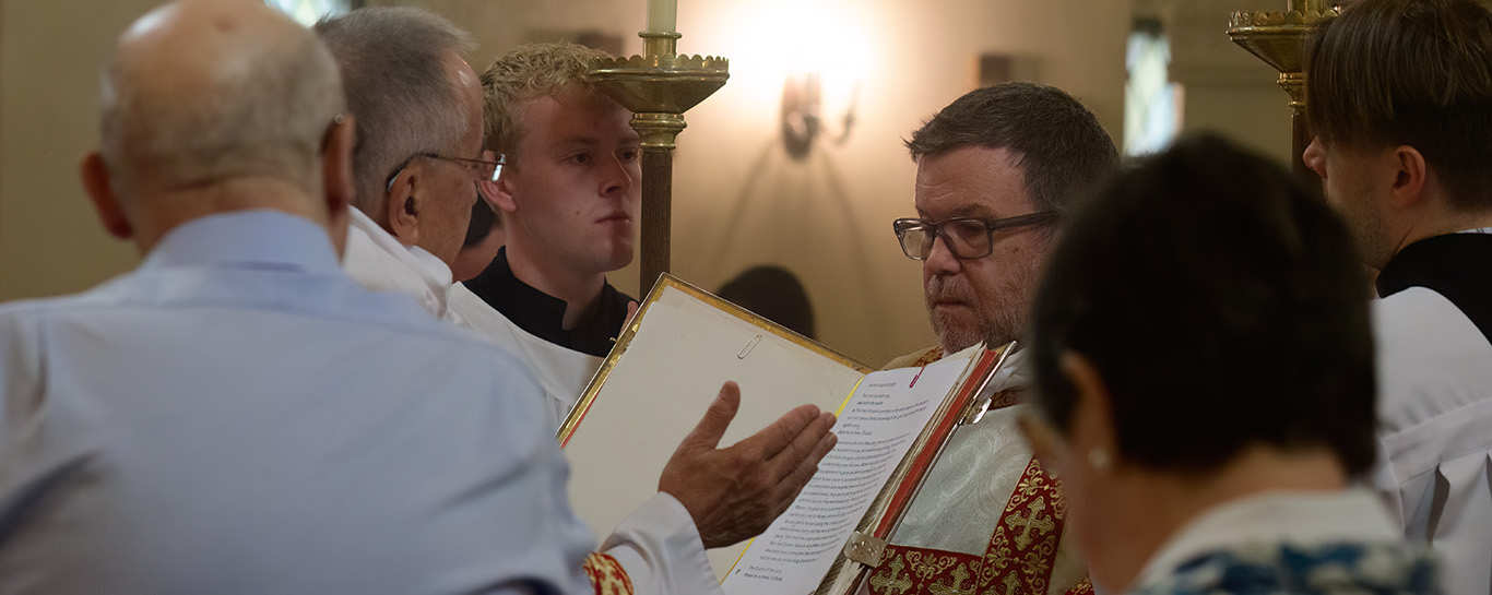 Fr Don Tudin reading the gospel