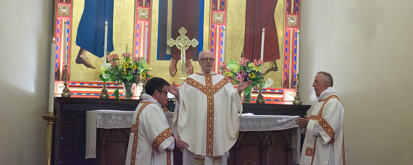 Fr Jim Beal giving absolution